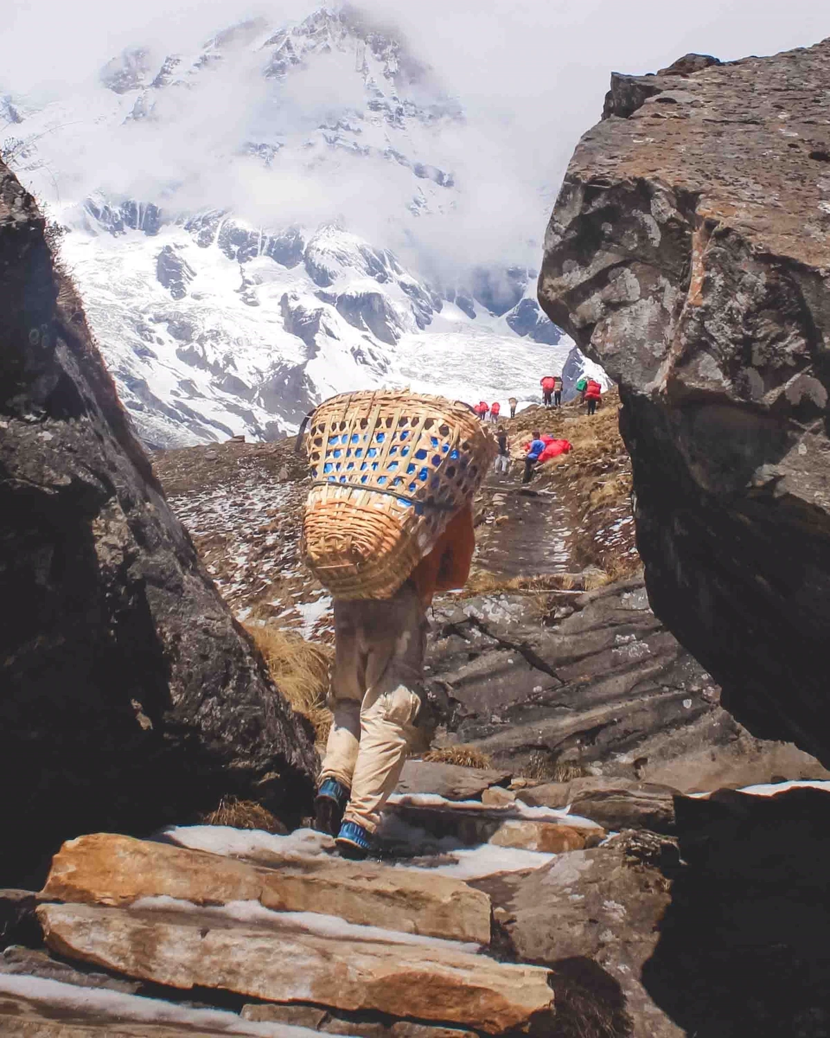 Porter carrying a traditional doko basket on a Himalayan trail